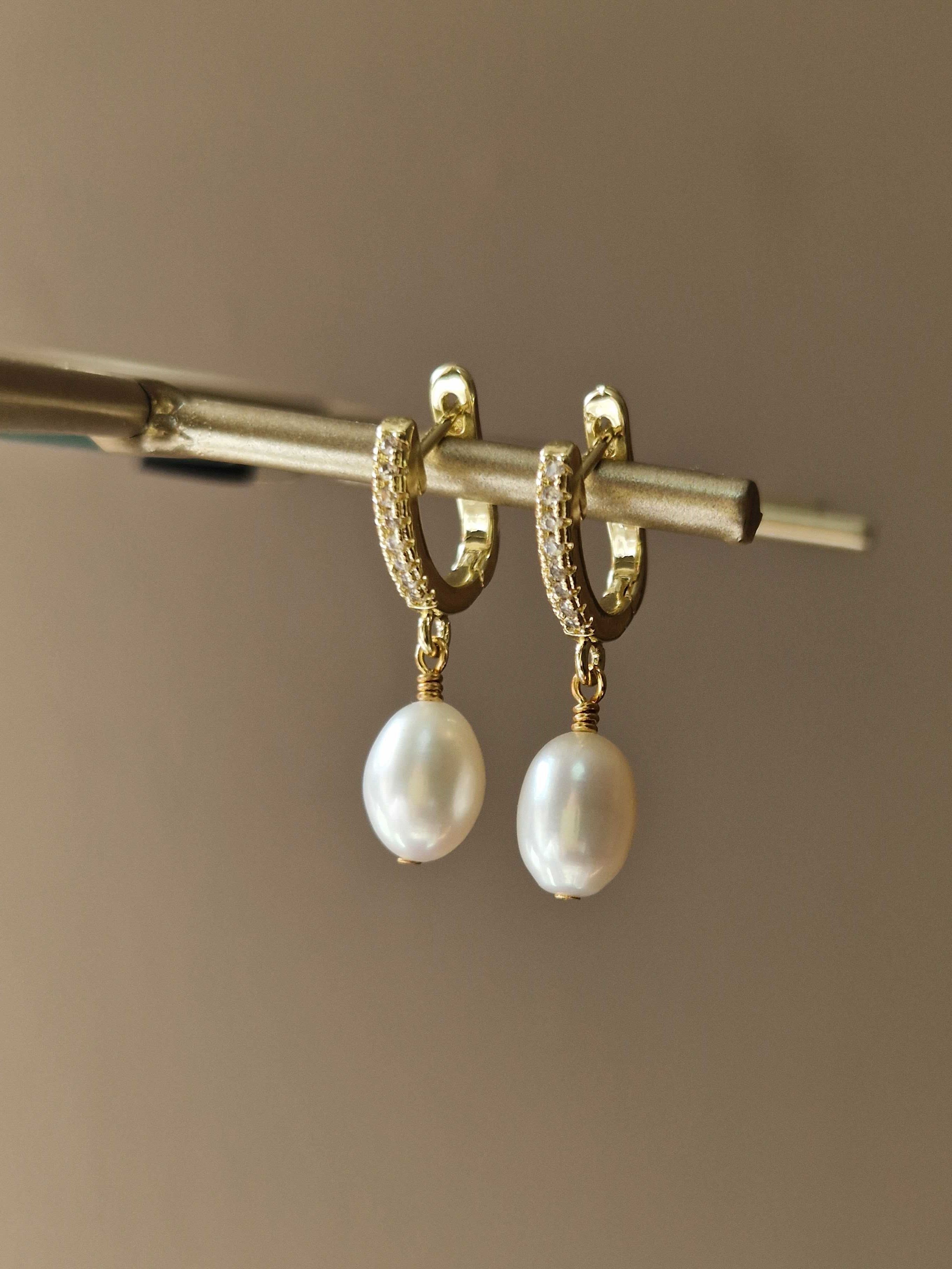 Elegant pearl drop statement earrings with dangle design – handmade bridal and bridesmaids jewelry displayed on a soft, neutral backdrop.