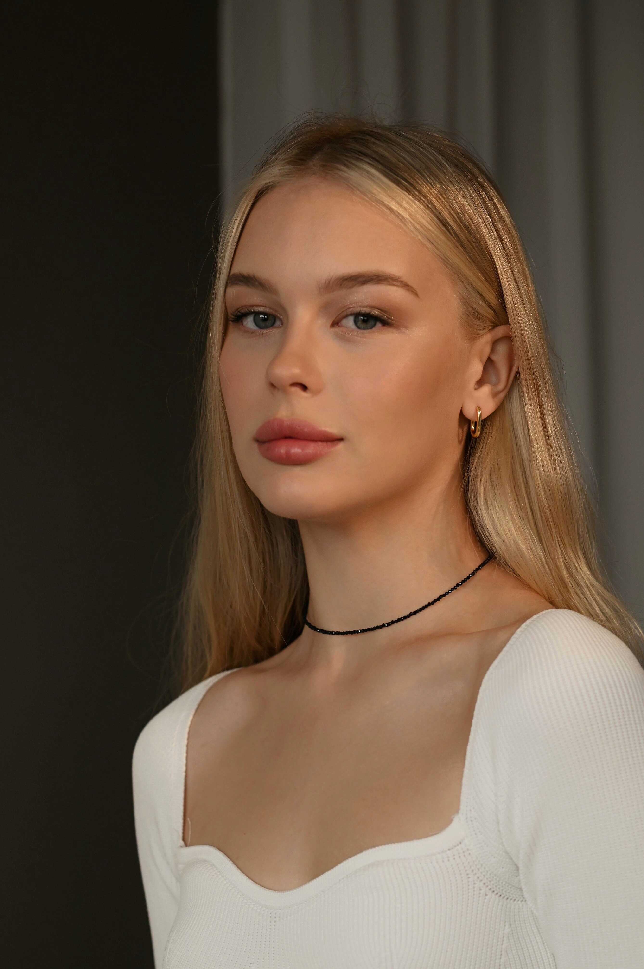 Black spinel beaded necklace on a beige fabric background