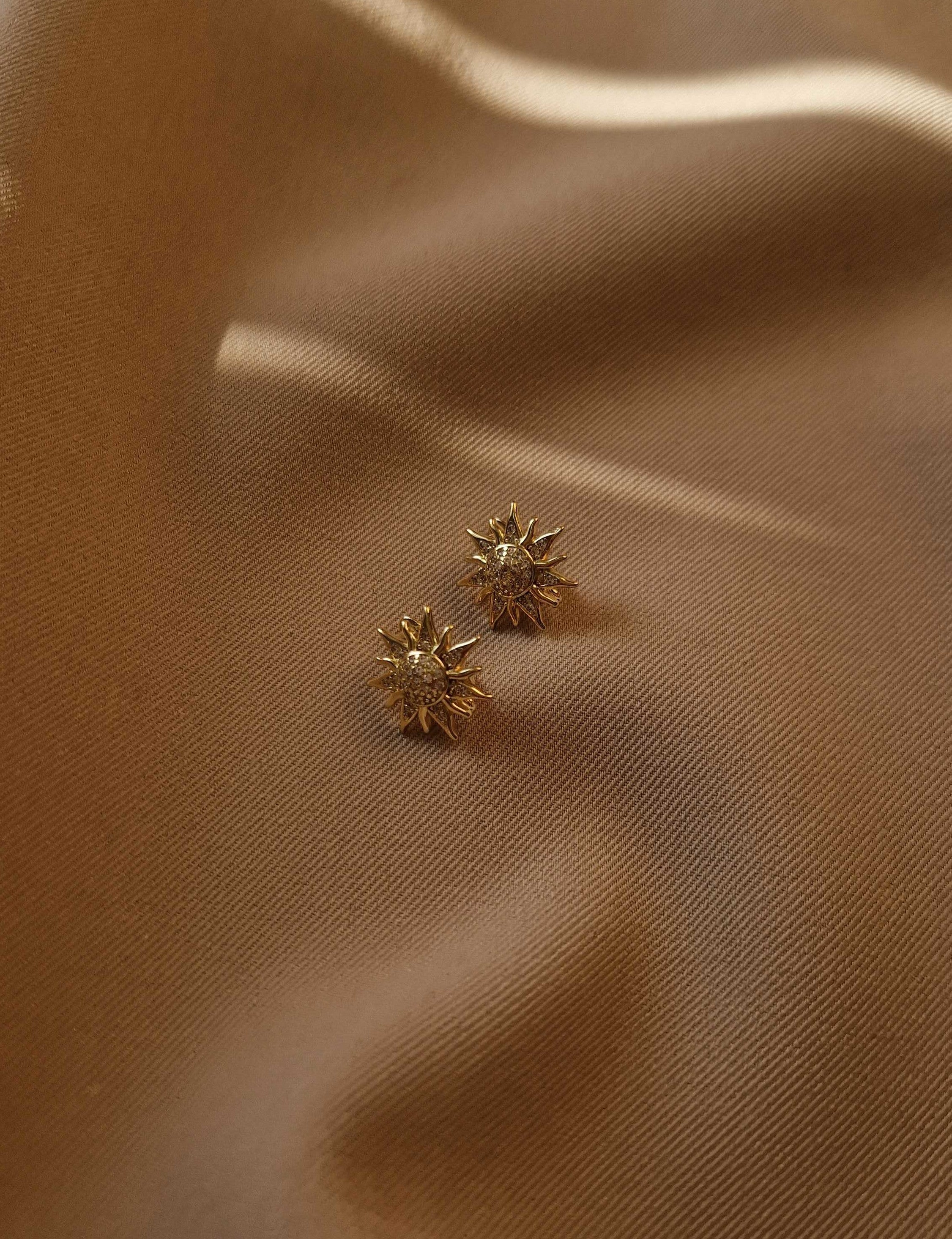 Elegant earrings adorned with shimmering cubic zirconia and finished with a secure English clasp, offering refined sparkle for everyday or special occasions.