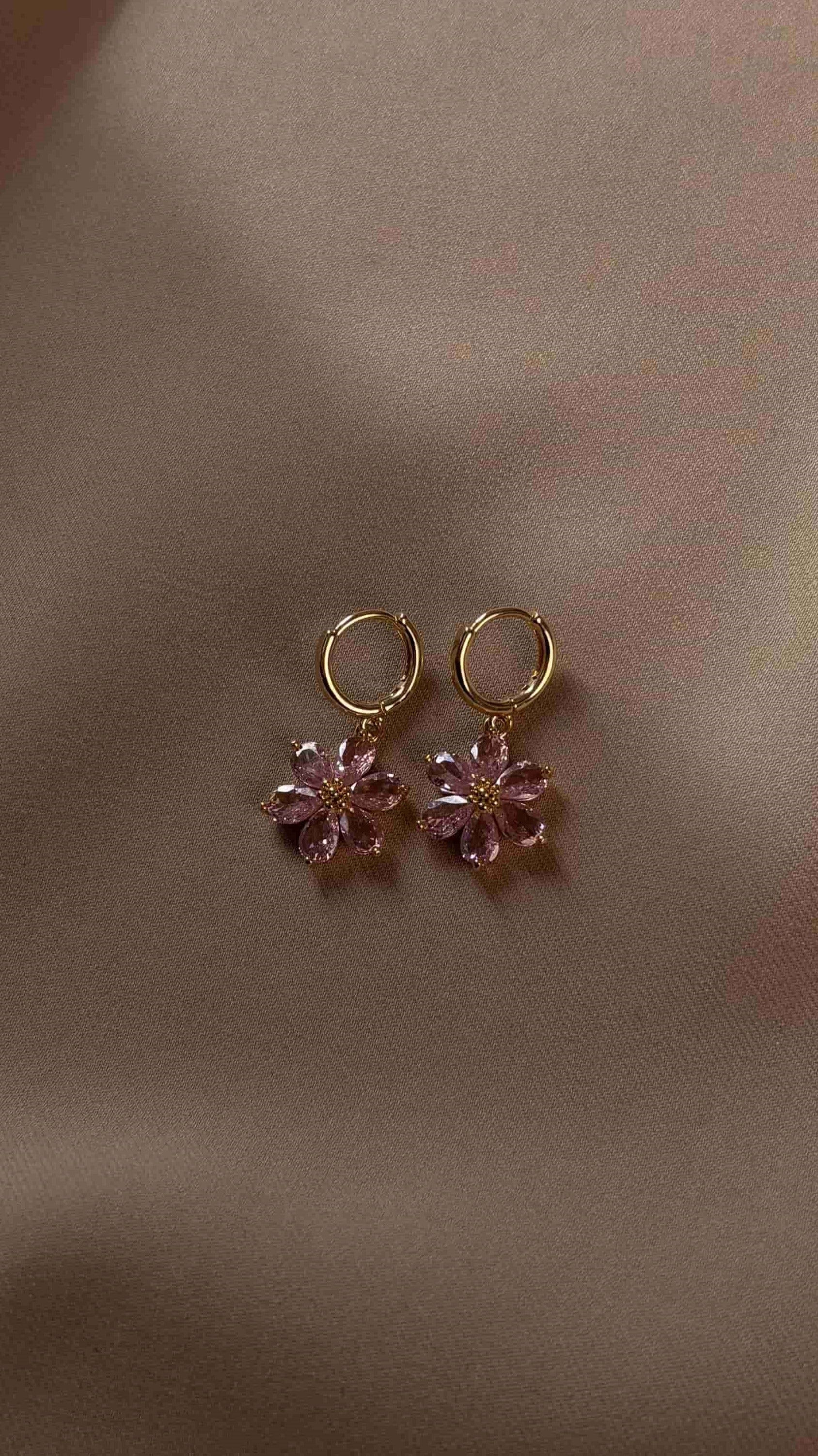 Elegant earrings with delicate pink flower accents. Lightweight and secure design adds a romantic touch to both everyday outfits and special occasion looks.