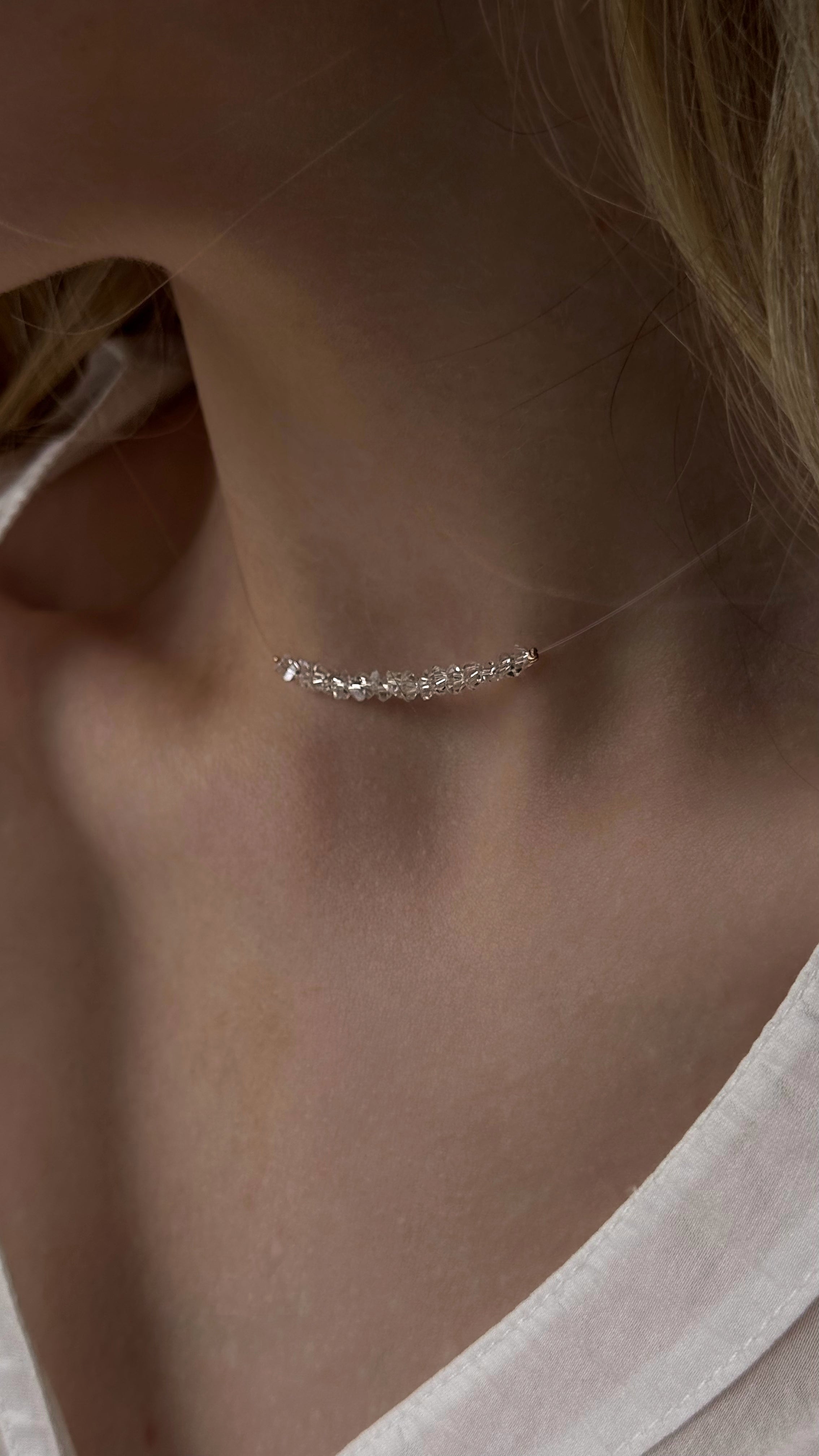 Elegant jewelry duo featuring a minimalist clear crystal bead choker on transparent non-stretch wire and matching stud earrings with dangling crystal drops — graceful and airy design adding sparkle and elegance to any look.