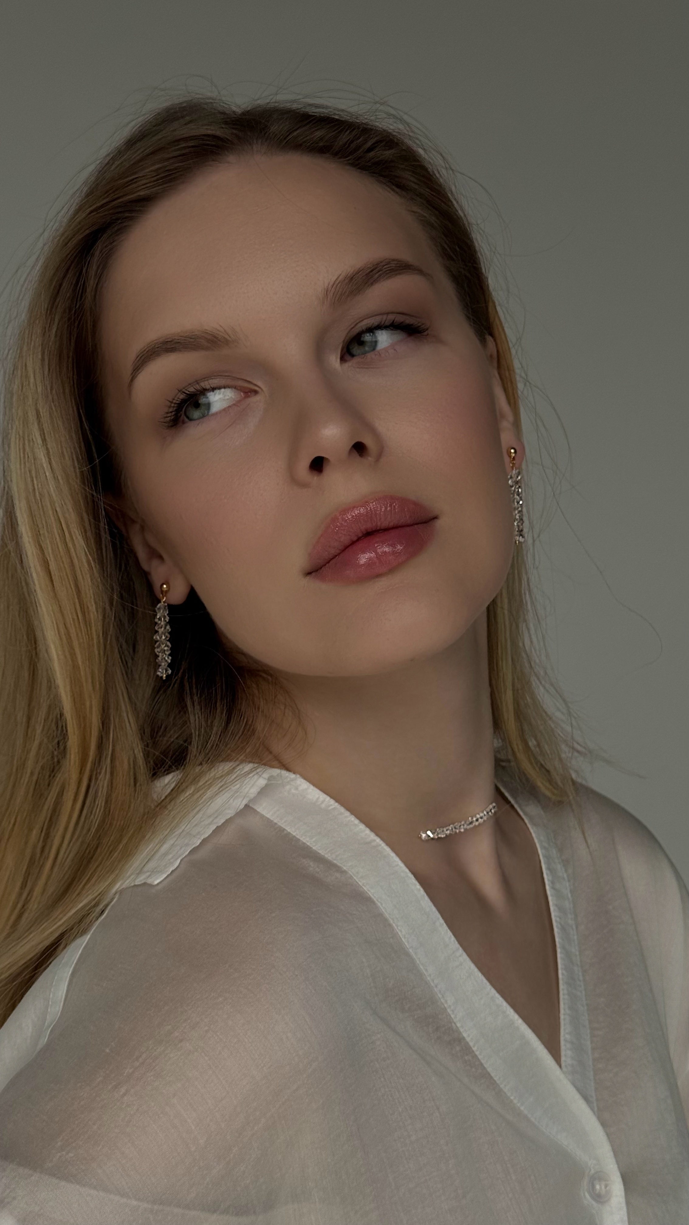 Elegant jewelry duo featuring a minimalist clear crystal bead choker on transparent non-stretch wire and matching stud earrings with dangling crystal drops — graceful and airy design adding sparkle and elegance to any look.