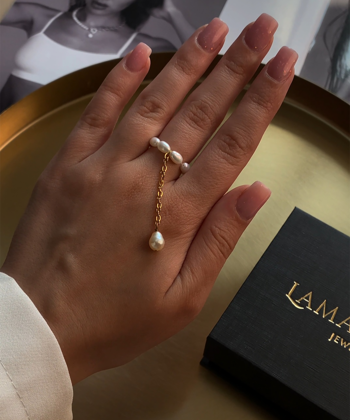 Elegant pearl ring with delicate band and single white pearl centerpiece.