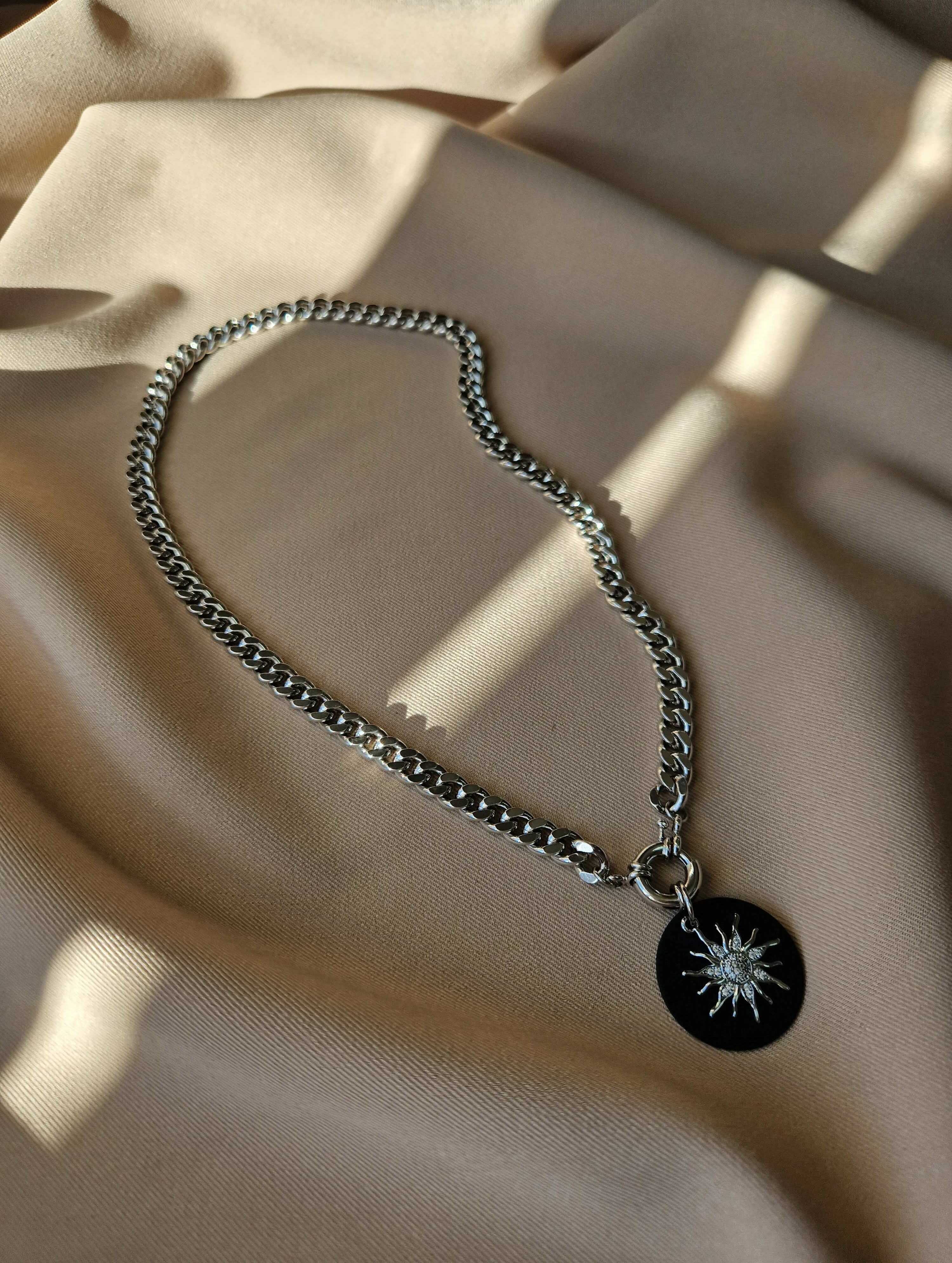 Bold chunky chain necklace with a sparkling detachable cubic zirconia pendant, crafted from rhodium-plated brass for a cool-toned, elegant shine.