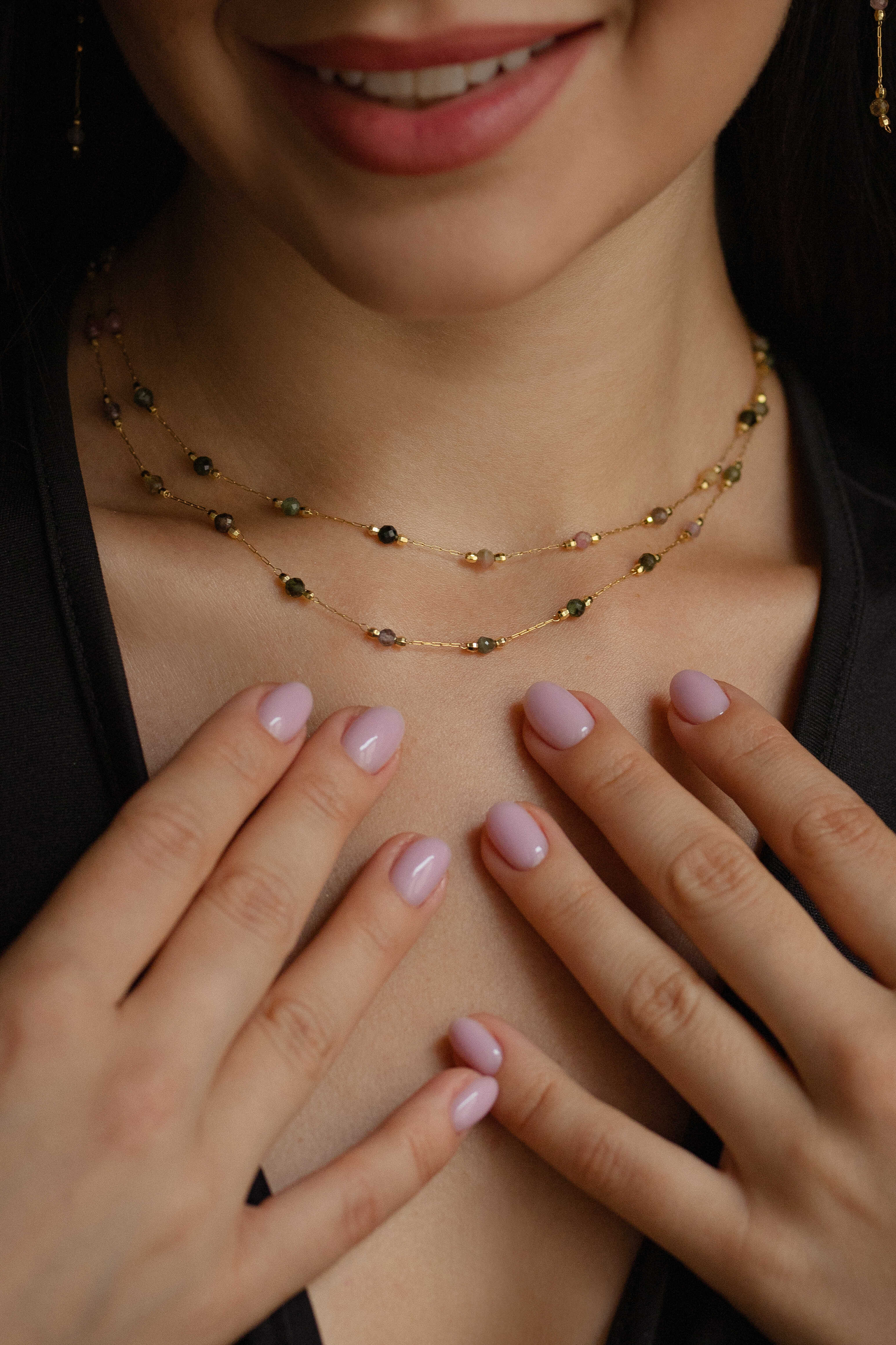 Double-layered gold-plated brass necklace with natural tourmaline accents and matching long stud earrings, offering a luxurious golden shine and elegant style.