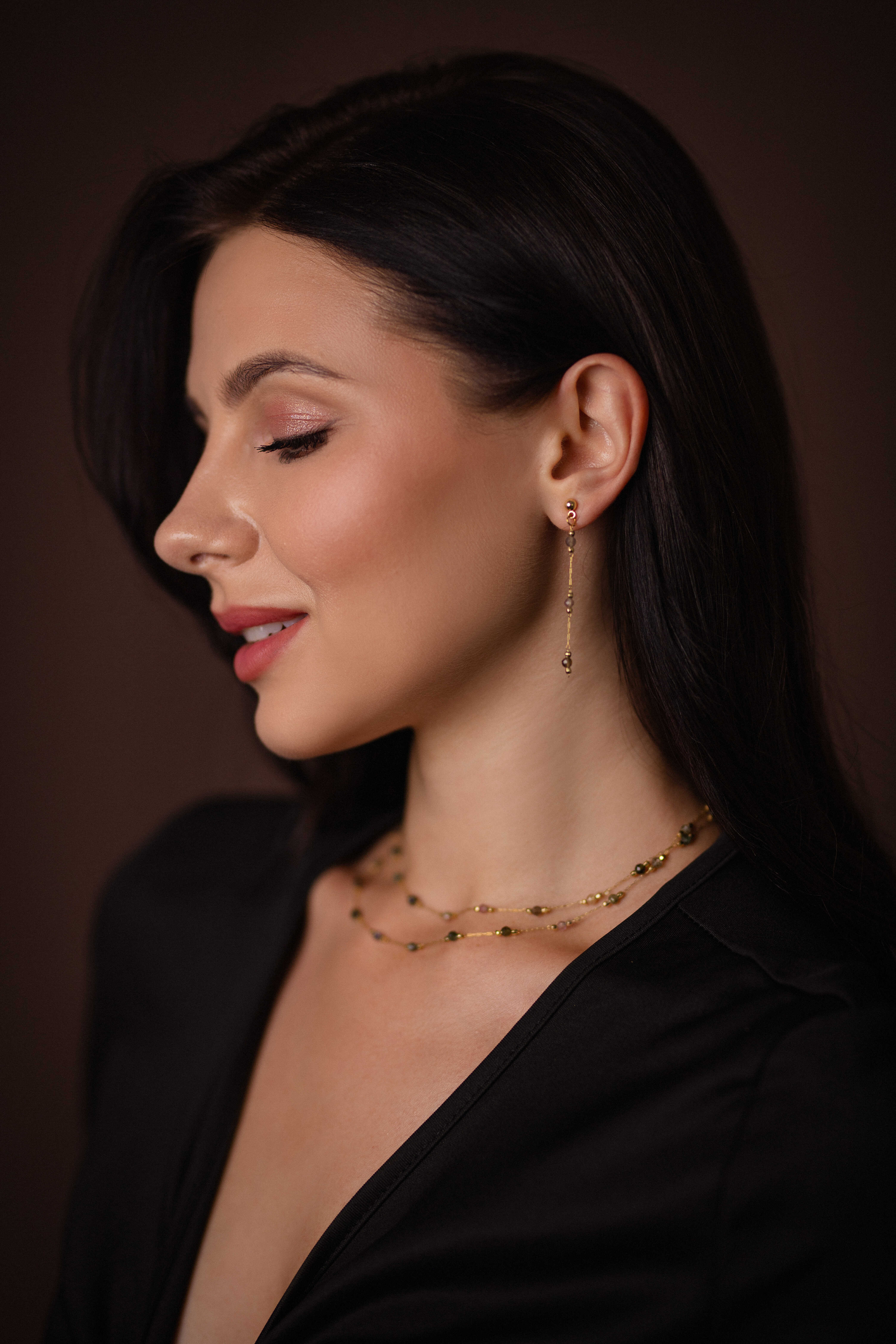 Double-layered gold-plated brass necklace with natural tourmaline accents, paired with long stud earrings featuring matching tourmaline gemstones, creating a luxurious and elegant jewelry set.