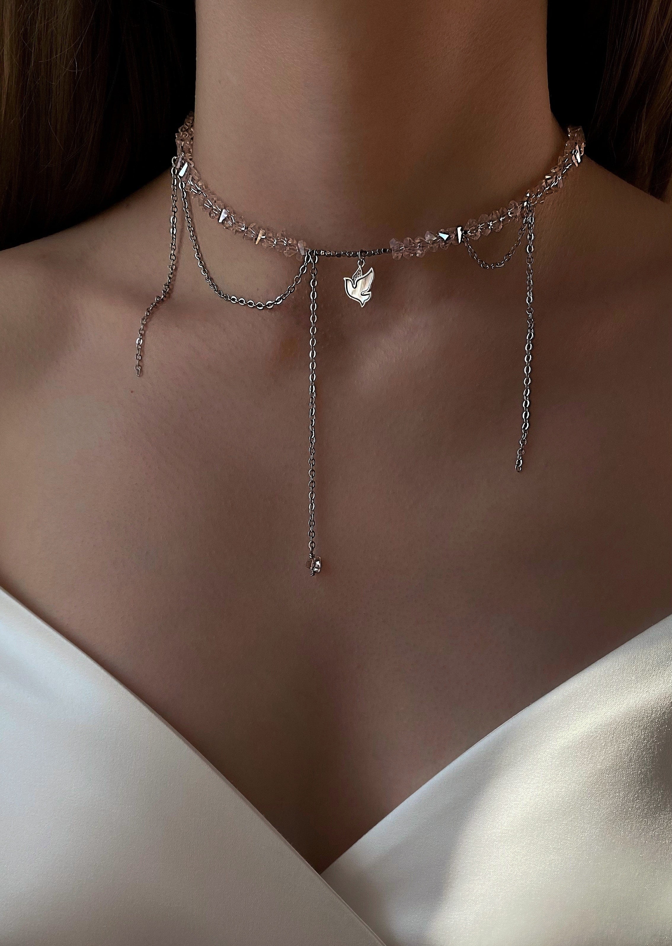 Delicate pink and silver necklace on a person wearing