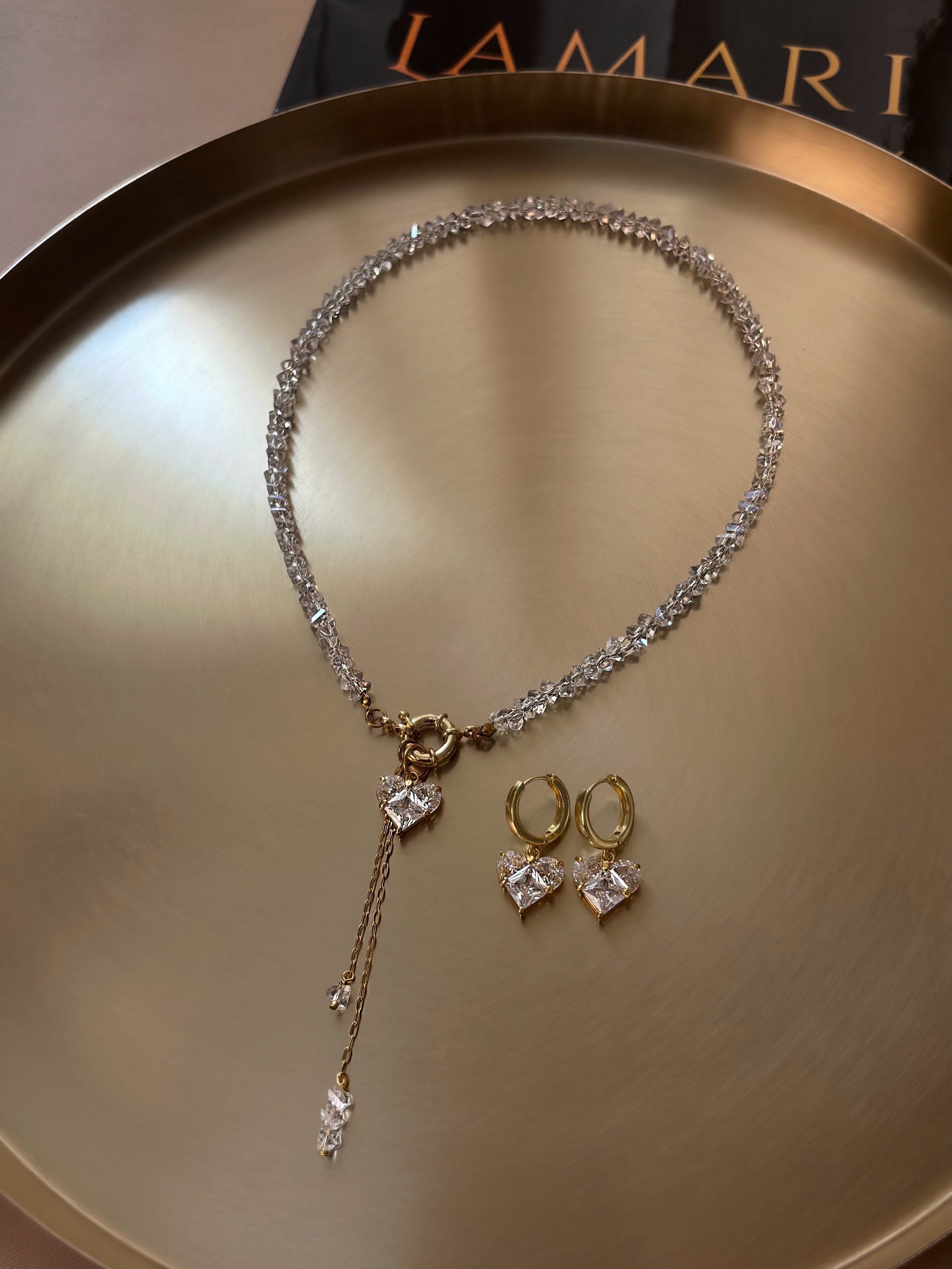Elegant necklace with hand-selected clear crystal beads, heart-shaped pendant, and statement clasp detail — transparent crystals paired with gold-tone hardware for a timeless accent perfect for everyday wear and special occasions.