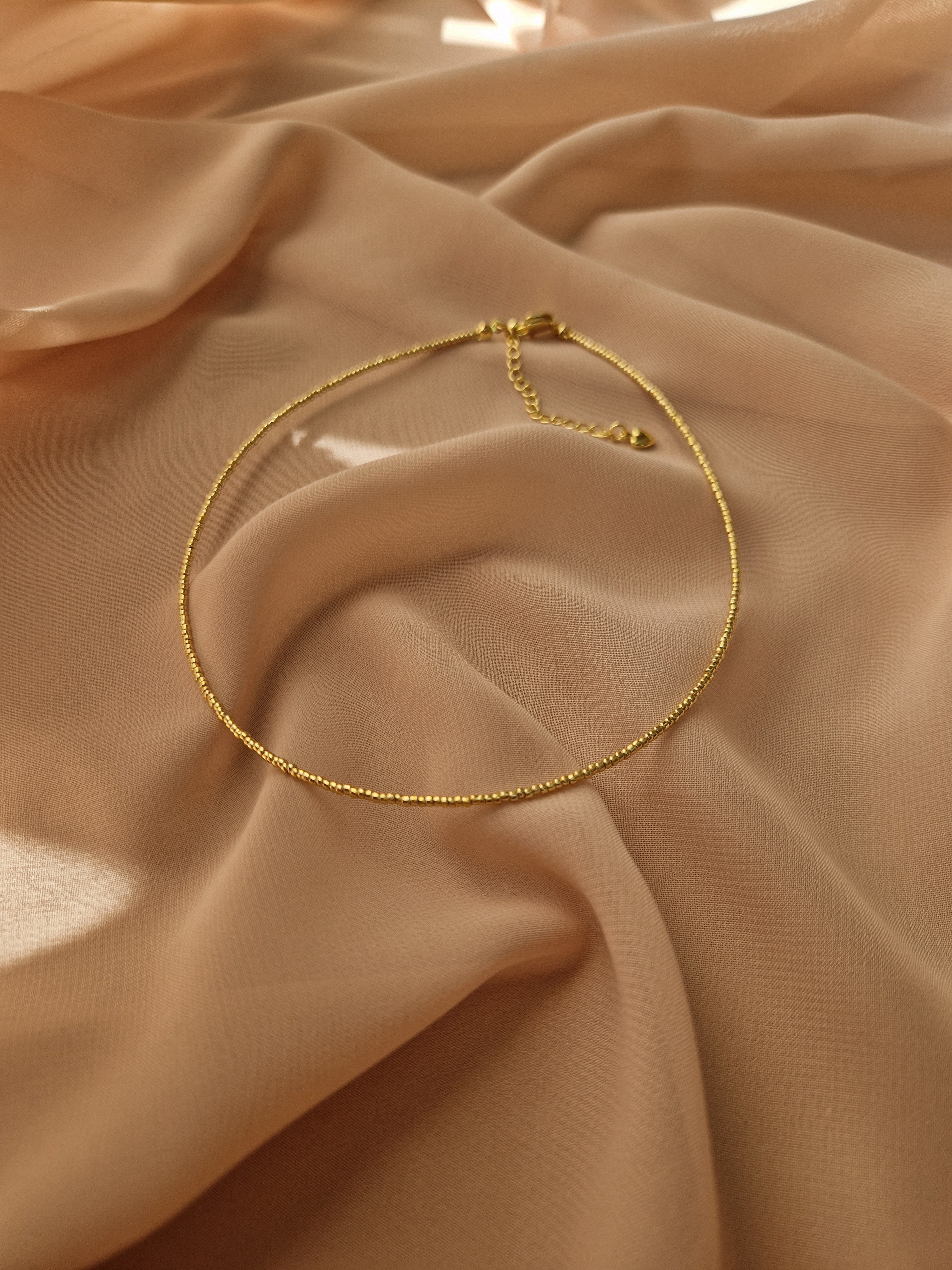 Choker made of Japanese jewelry-grade seed beads with a galvanic finish. Gold-tone stainless steel hardware. Standard length 36 cm with a 6 cm extender