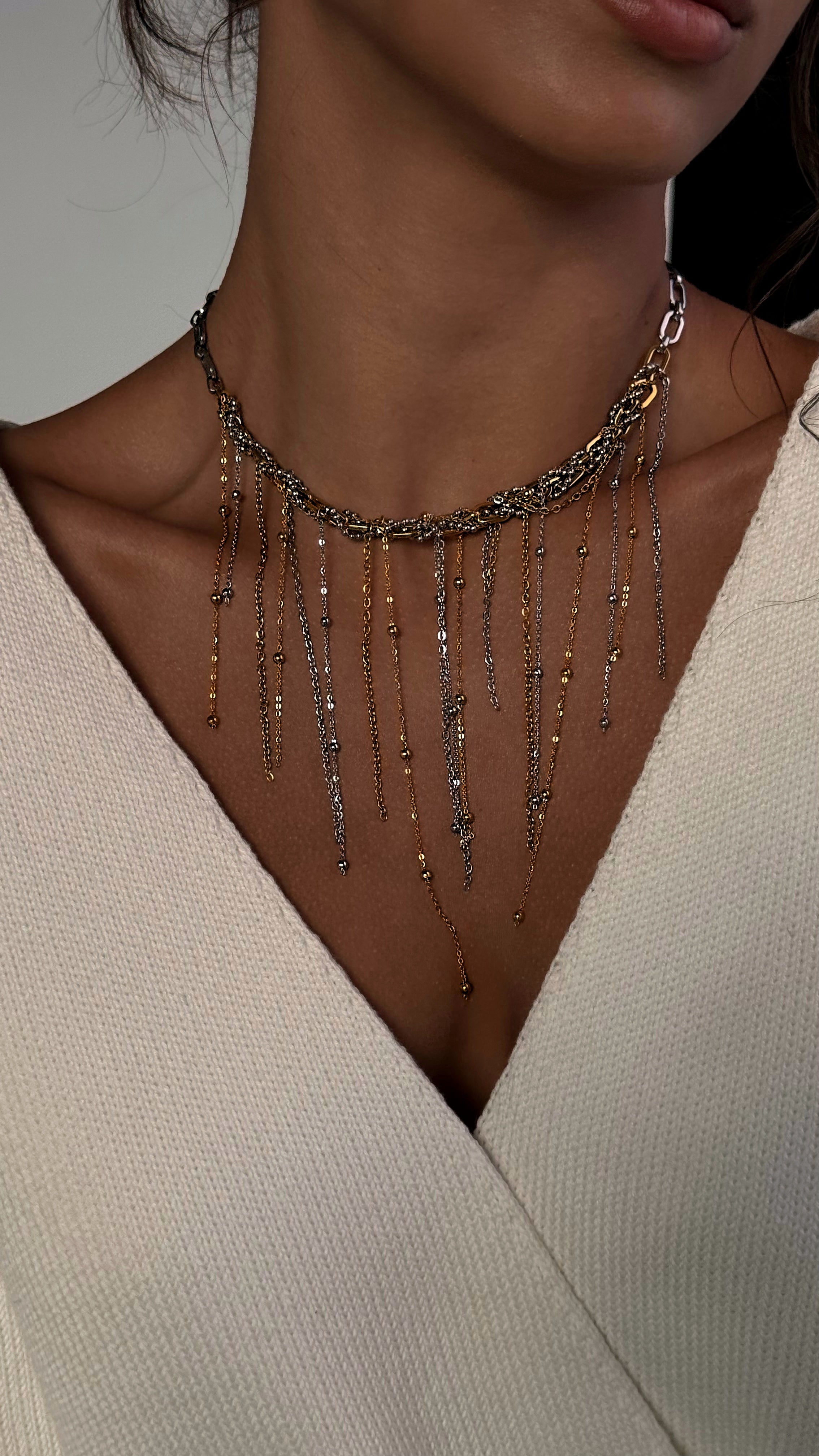 Bold bi-color chain necklace combining gold and silver tones with mixed chain sizes and textures, crafted from jewelry-grade stainless steel for a modern, durable look.