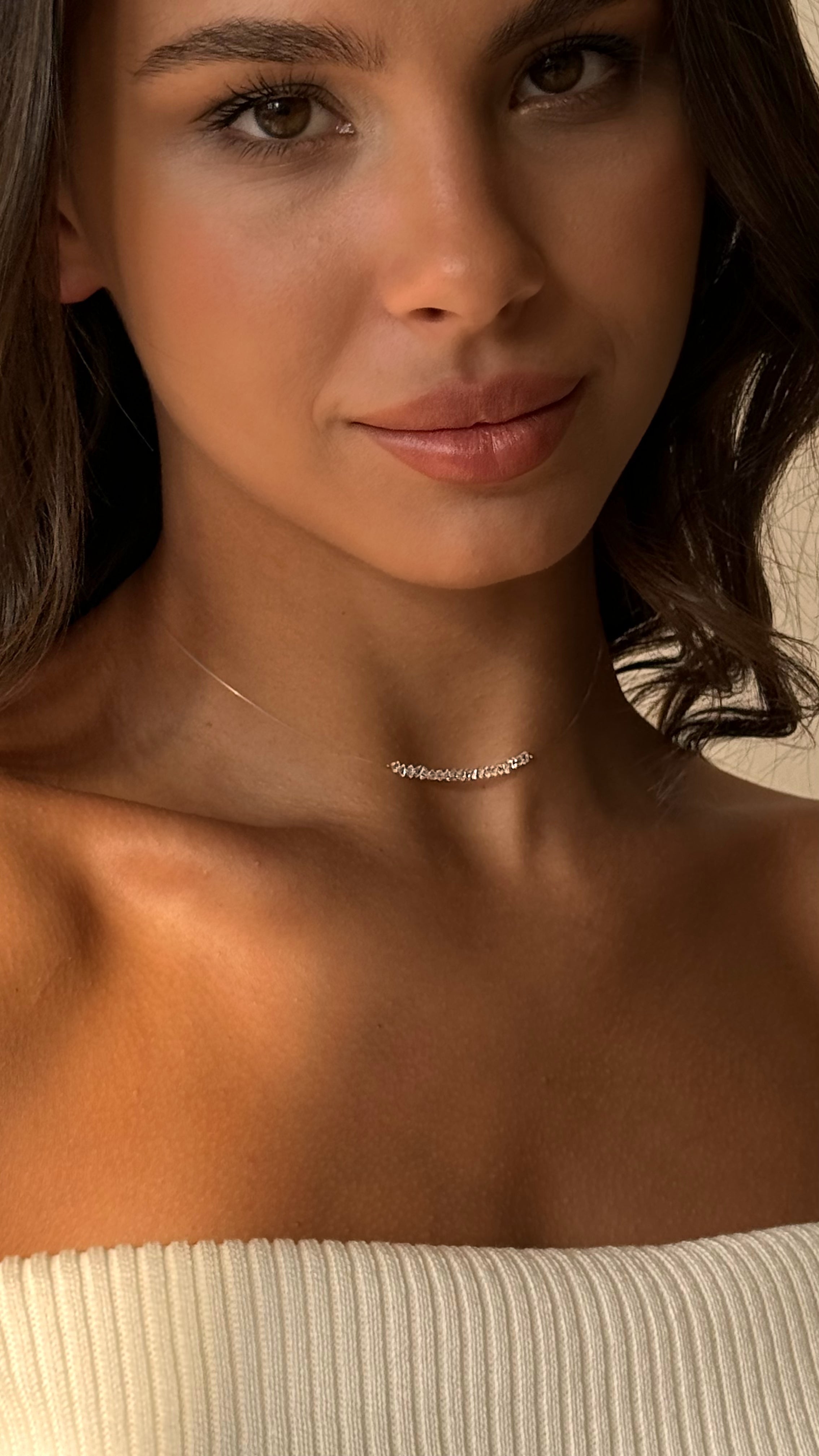 Delicate minimalist choker with transparent faceted crystal beads strung on clear flexible jewelry wire, offering a weightless and elegant look with lasting comfort.
