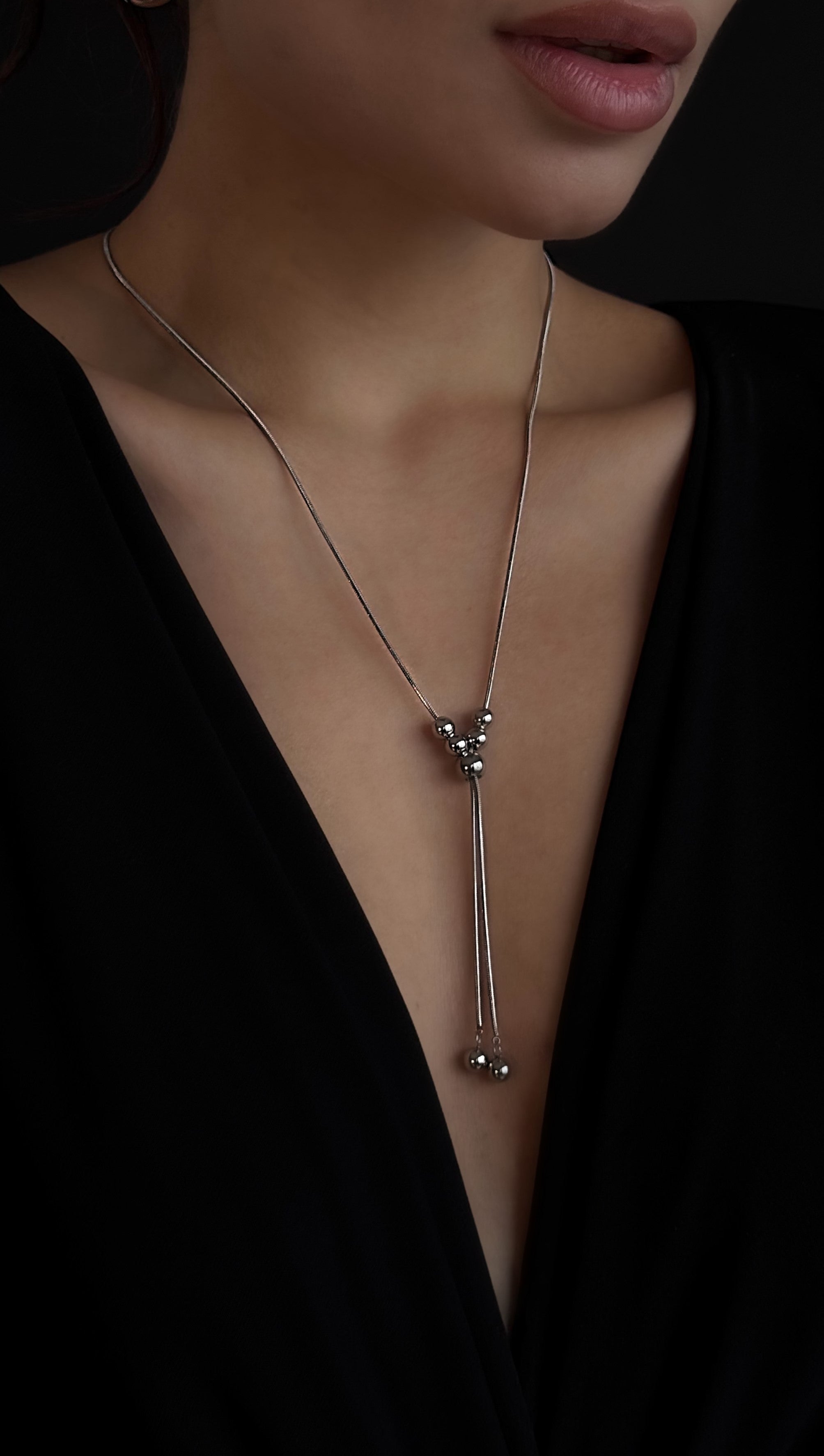 Trendy silver-tone lariat necklace made from jewelry-grade stainless steel, designed for versatile wear with multiple styling options and durable finish.
