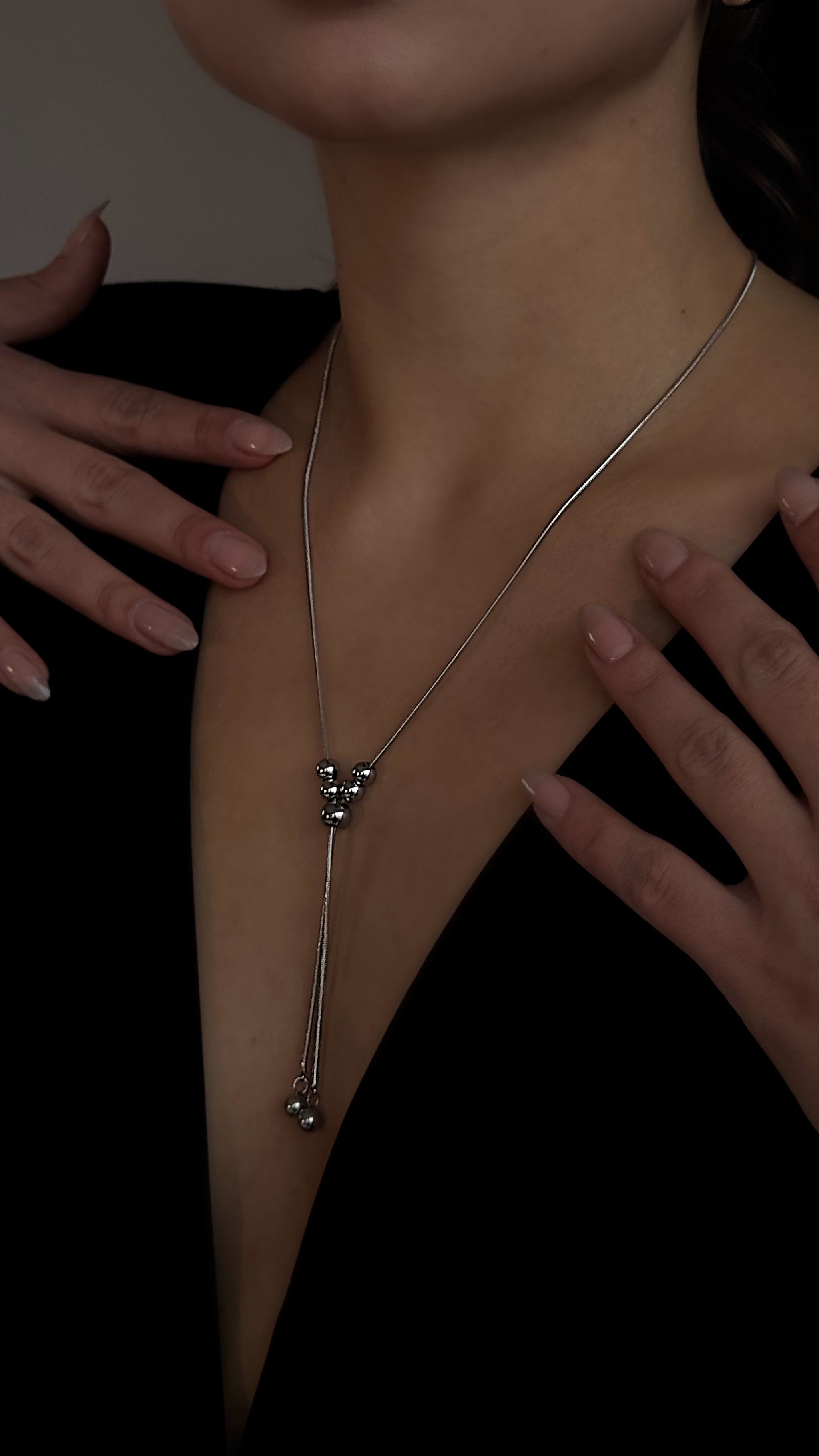 Trendy silver-tone lariat necklace made from jewelry-grade stainless steel, designed for versatile wear with multiple styling options and durable finish.