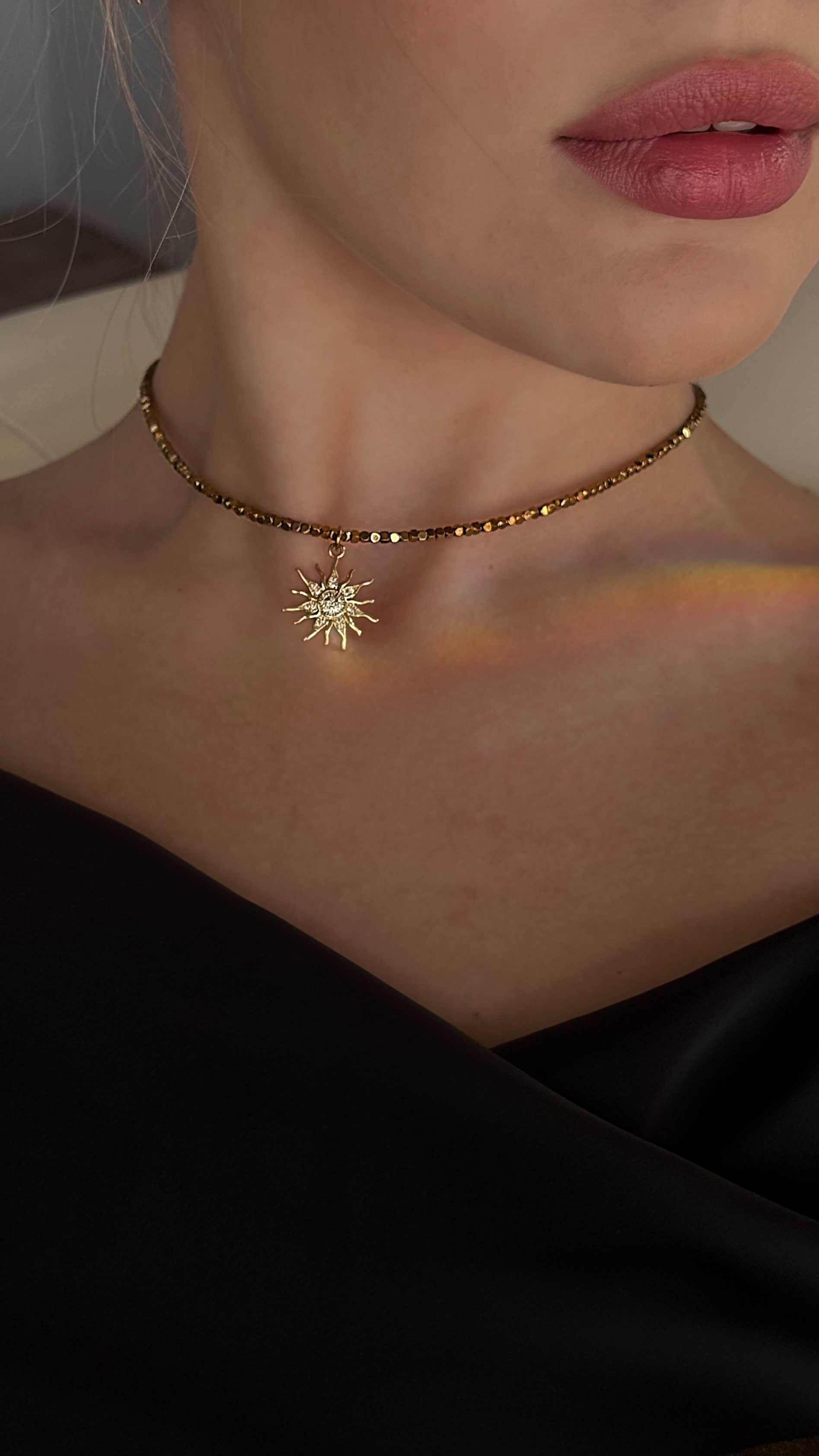 Choker made of hematite beads with a sun pendant