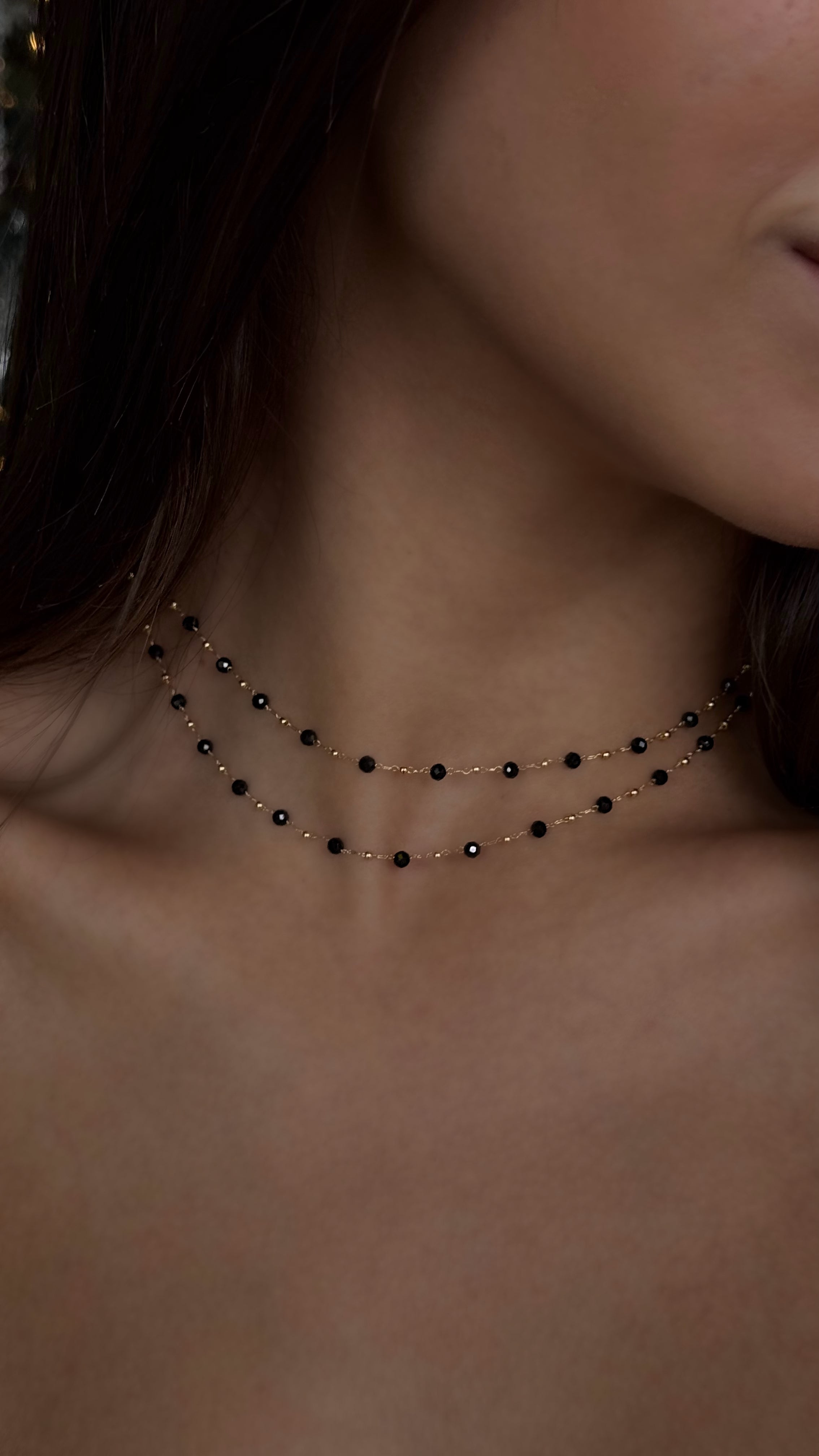 Double-layered gold-plated brass necklace with natural spinel accents, paired with long stud earrings featuring genuine spinel stones, creating a warm and sophisticated jewelry set.