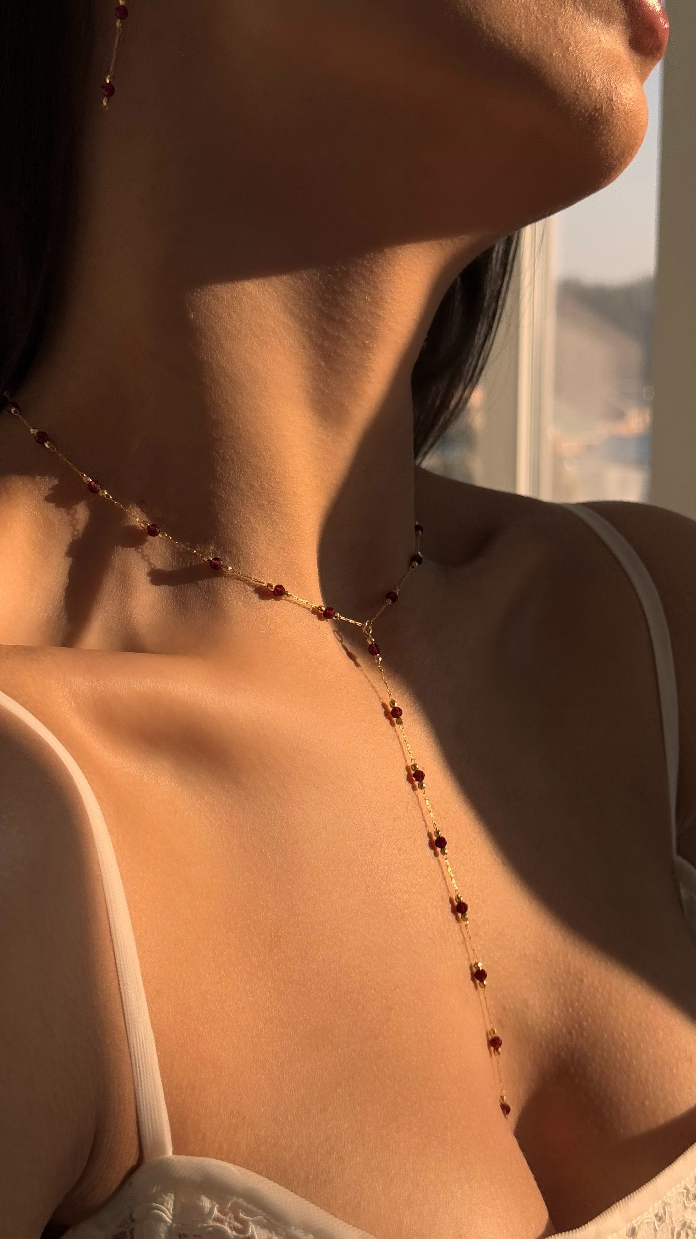 Elegant jewelry set with an 18K gold-plated brass lariat necklace featuring genuine natural garnet stones and matching garnet stud earrings, perfect for refined everyday or special occasion wear.