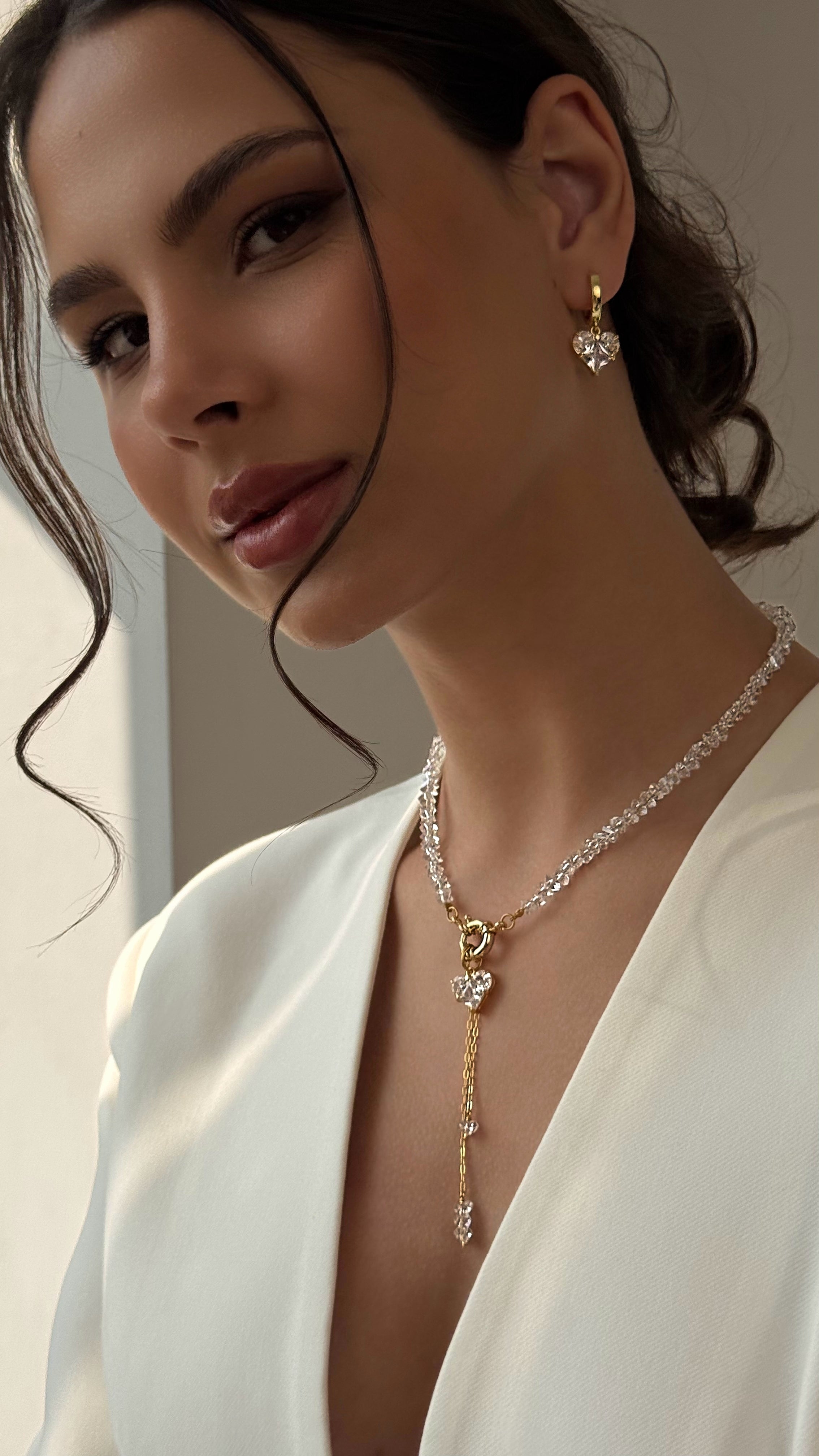 Elegant necklace with hand-selected clear crystal beads, heart-shaped pendant, and statement clasp detail — transparent crystals paired with gold-tone hardware for a timeless accent perfect for everyday wear and special occasions.