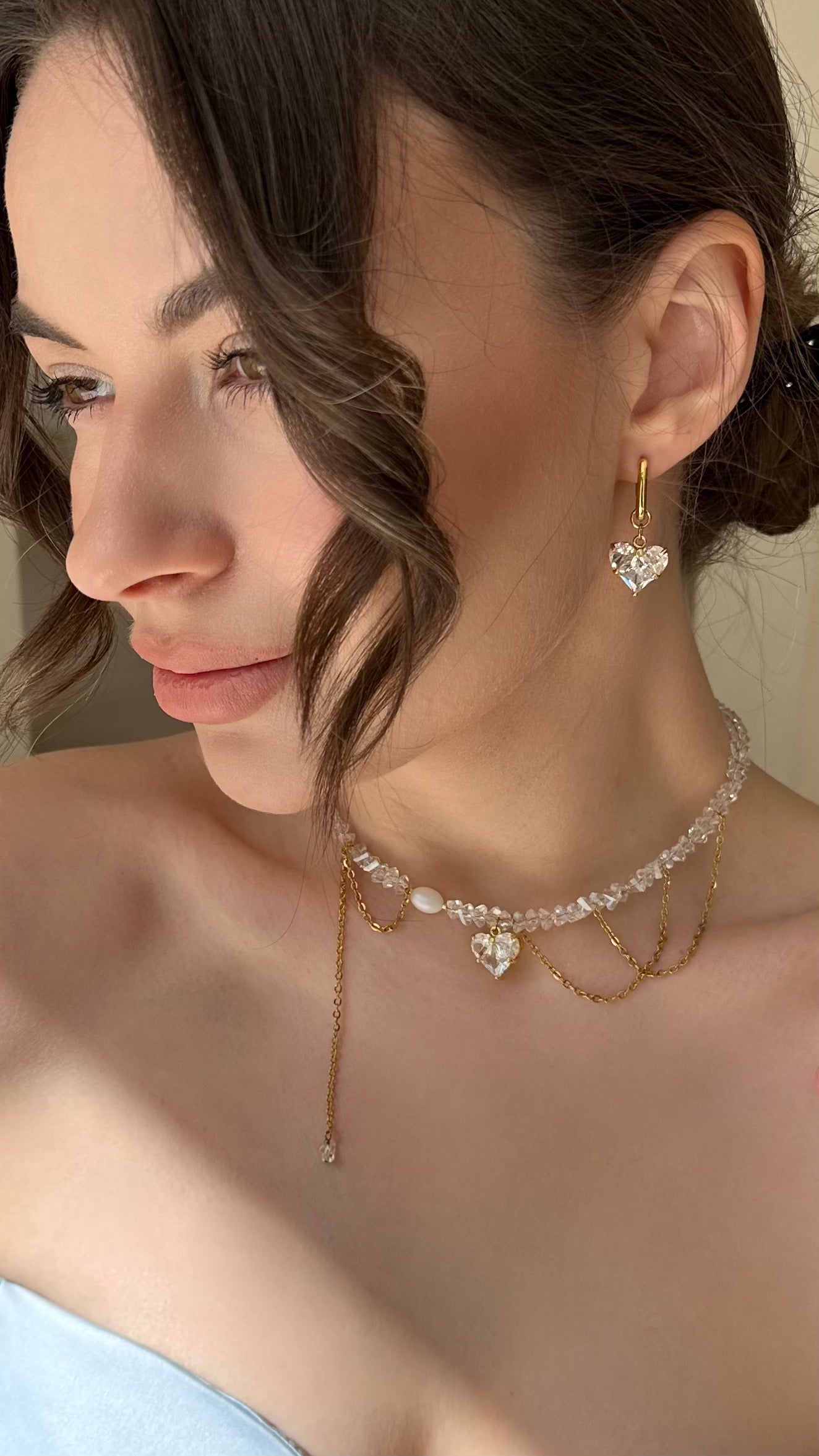 Crystal Heart Pendant Choker and Earrings Set featuring shimmering glass crystal beads, a delicate gold-tone heart pendant, and matching elegant earrings. The necklace has a refined chain design, combining sparkle and modern elegance—perfect for everyday wear or special occasions.