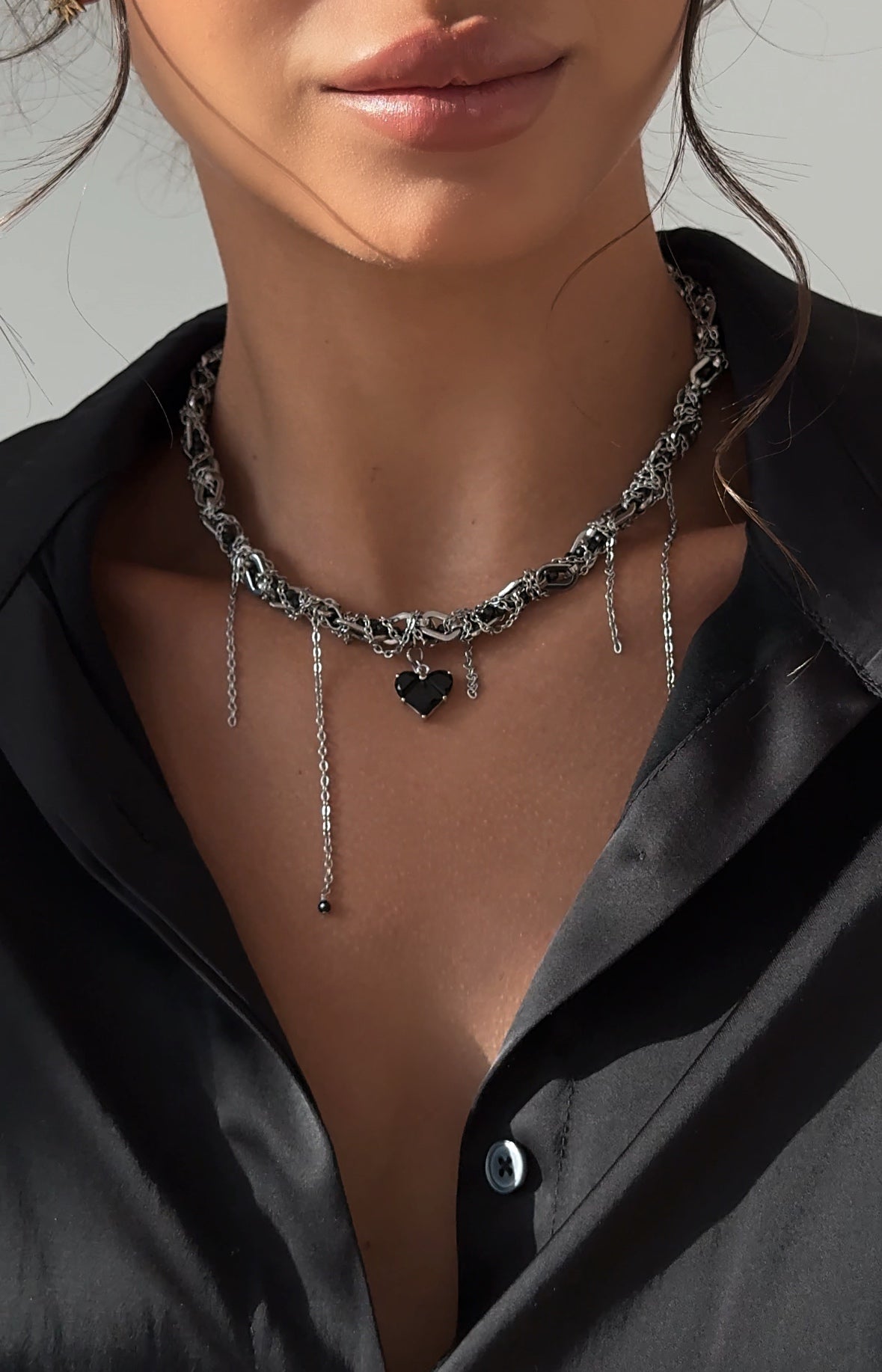 Layered silver-tone necklace with black cubic zirconia accents, crafted from stainless steel and rhodium-plated brass — modern and sophisticated design.