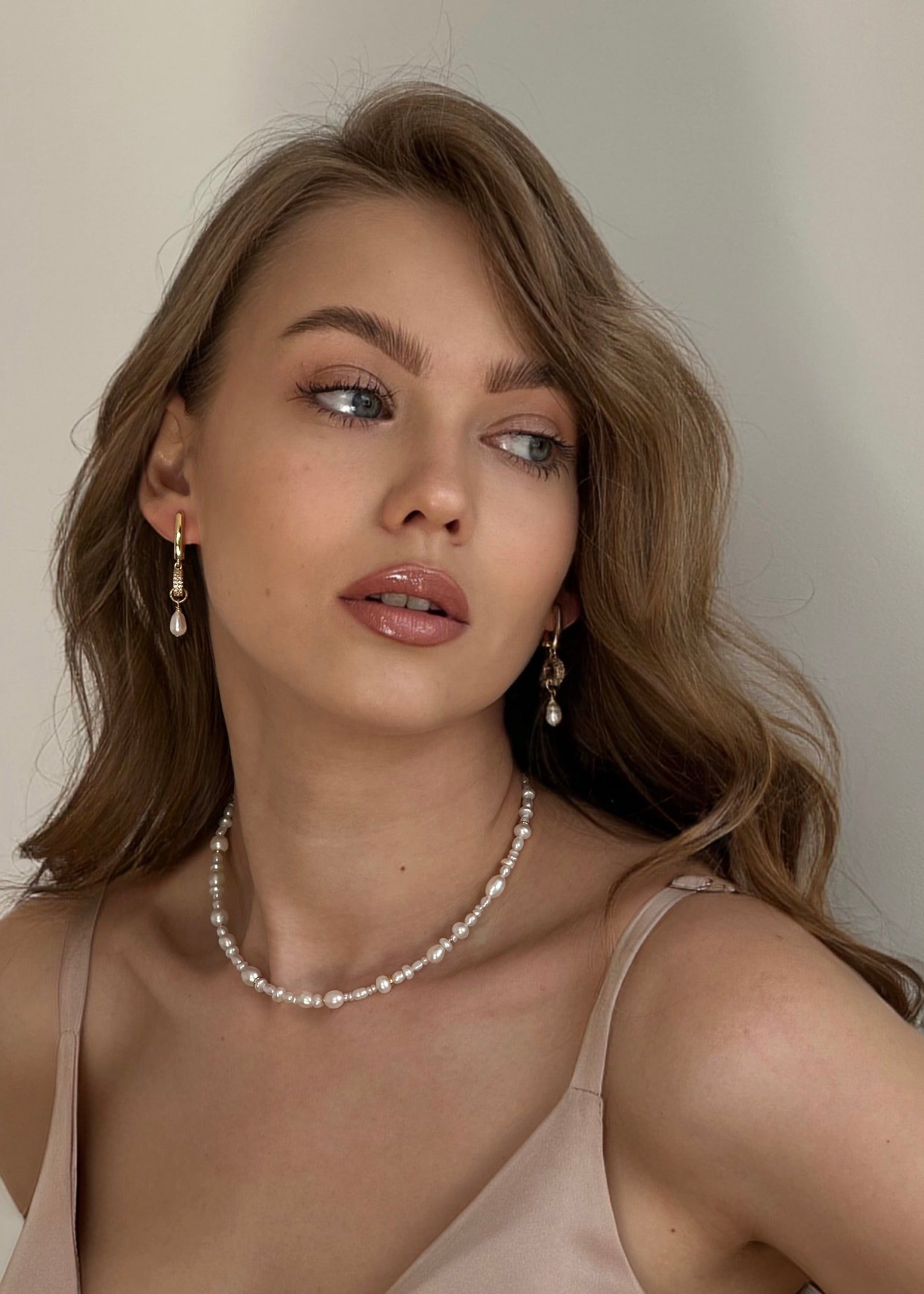 Jewelry set with mixed freshwater pearls featuring a gold-tone choker, adjustable bracelet, and delicate pearl drop earrings – elegant handmade gift for her