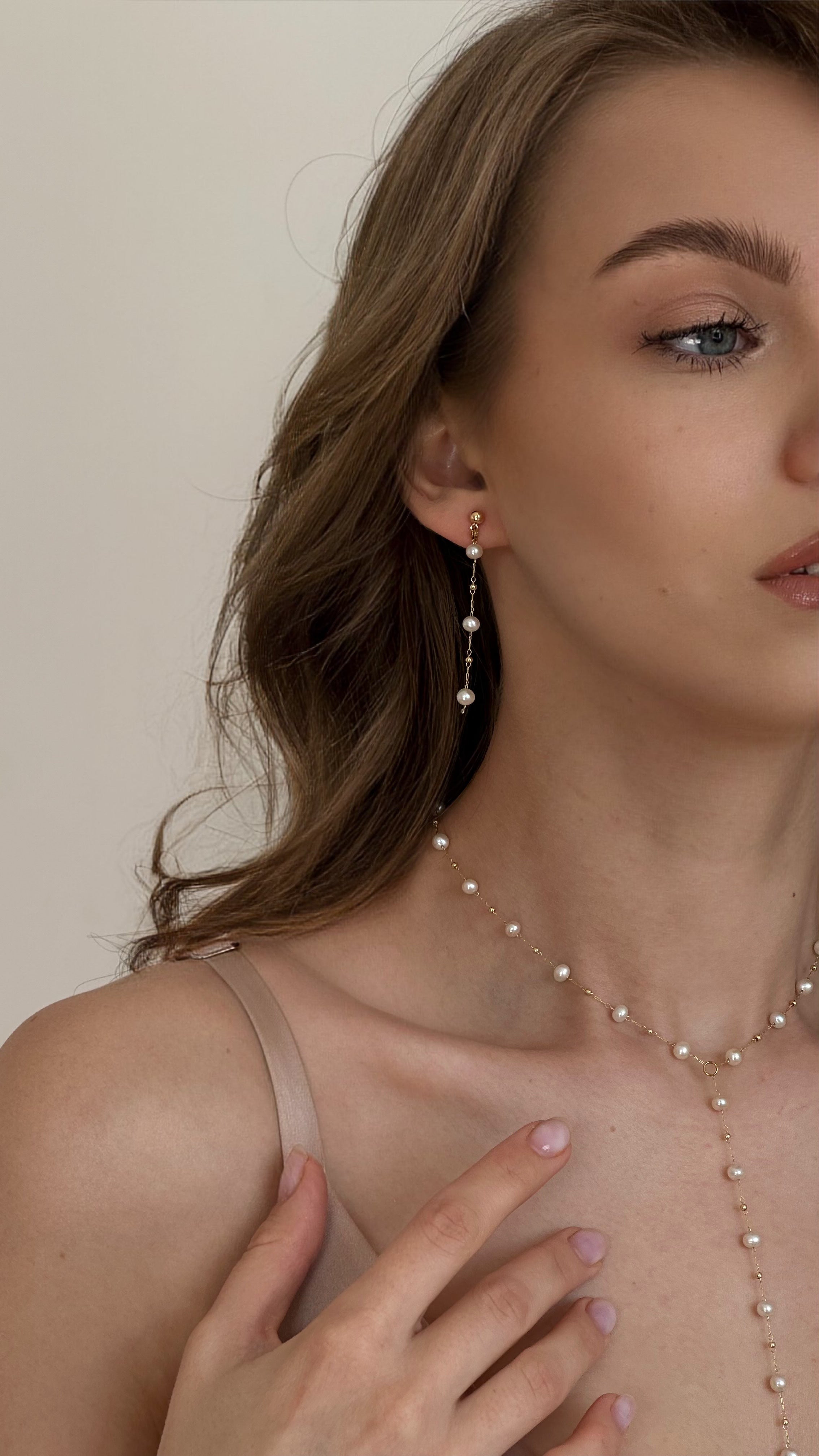Elegant Y-shaped lariat necklace with natural freshwater pearls on a gold-tone chain, showcasing a delicate and refined design perfect for special occasions and everyday wear.