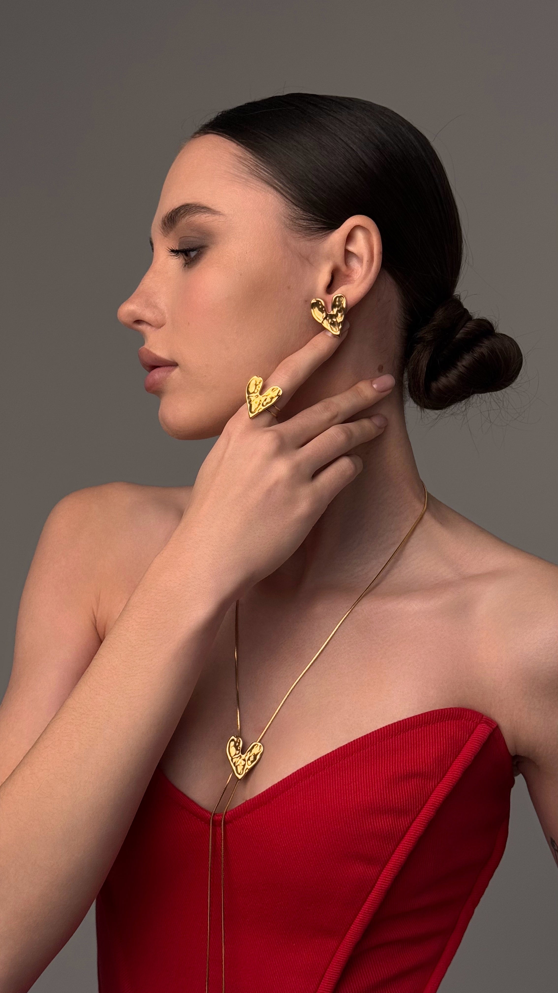 Adjustable lariat necklace with sliding heart pendant, crafted from gold-tone stainless steel — elegant and versatile design offering timeless charm and customizable length, perfect for layering or wearing solo.
