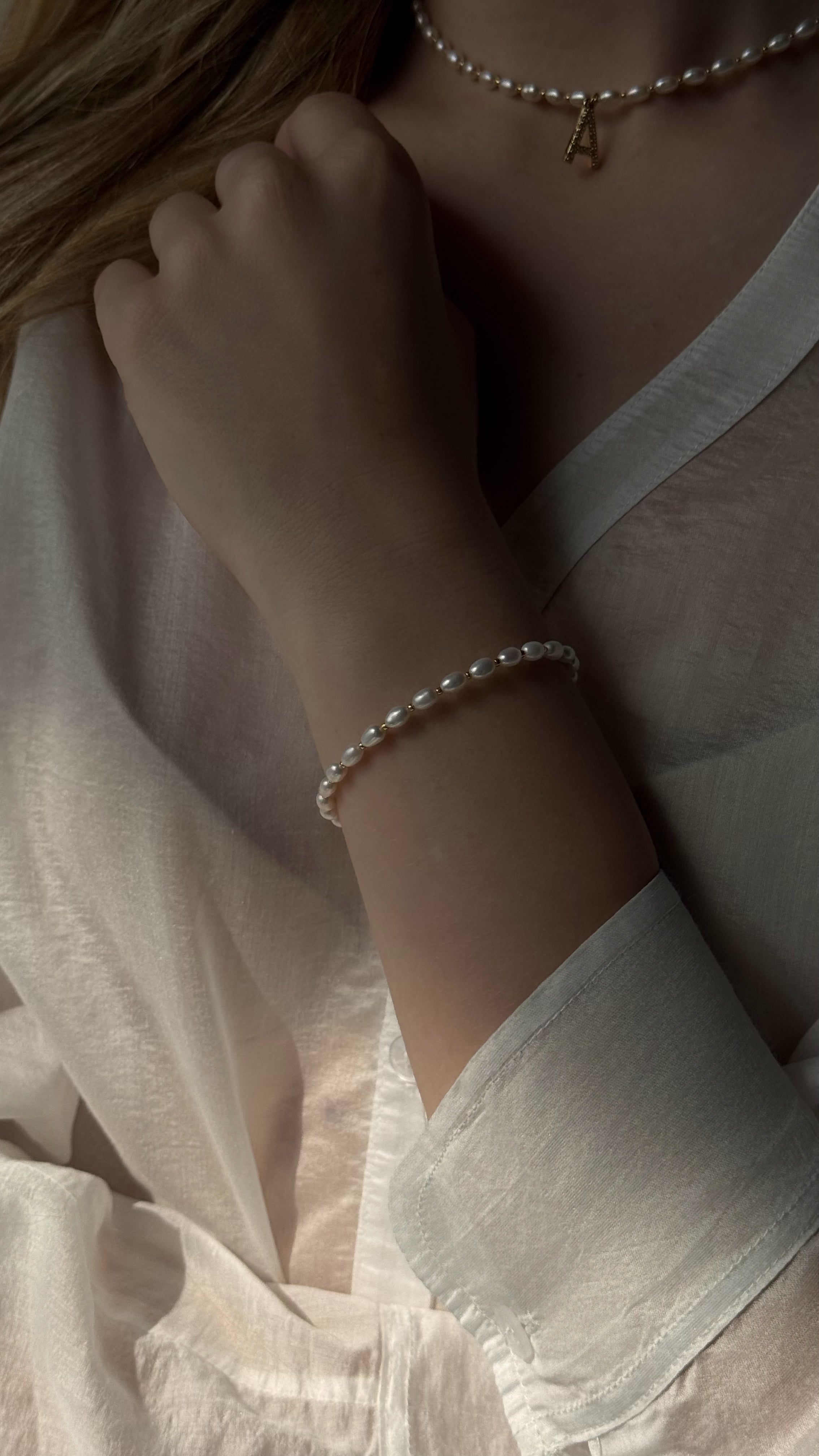 Close-up of a person wearing a pearl bracelet 