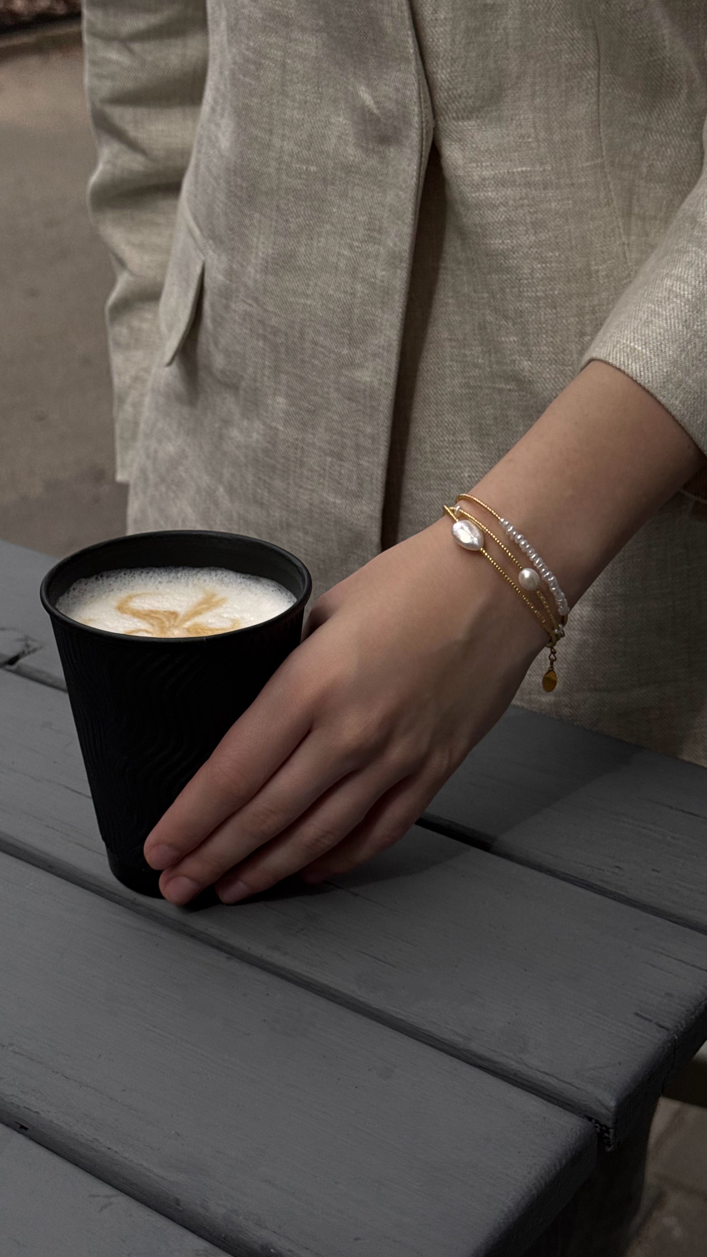 Triple-strand bracelet with Japanese seed beads and natural freshwater pearls in various shapes and sizes, featuring soft golden accents for an elegant and feminine look.
